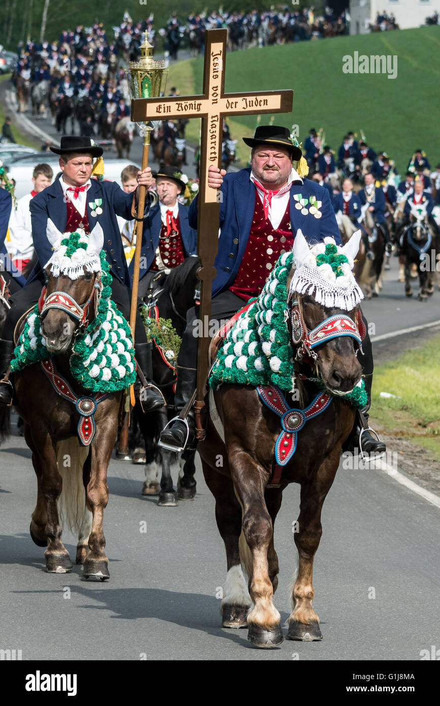 Bad Koetzing, Germany. 16th May, 2016. Participants in the Koetzing Pentecost Ride ride their horses near Bad Koetzing, Germany, 16 May 2016. The procession of 900 horsemen is one of the oldest traditional events in Bavaria. The 'Maennerleut' make an around seven-kilometer pilgrimage on the back of richly adorned horses from Bad Koetzting to St. Nicholas' Church in Steinbuehl. Photo: ARMIN WEIGEL/dpa/Alamy Live News Stock Photo