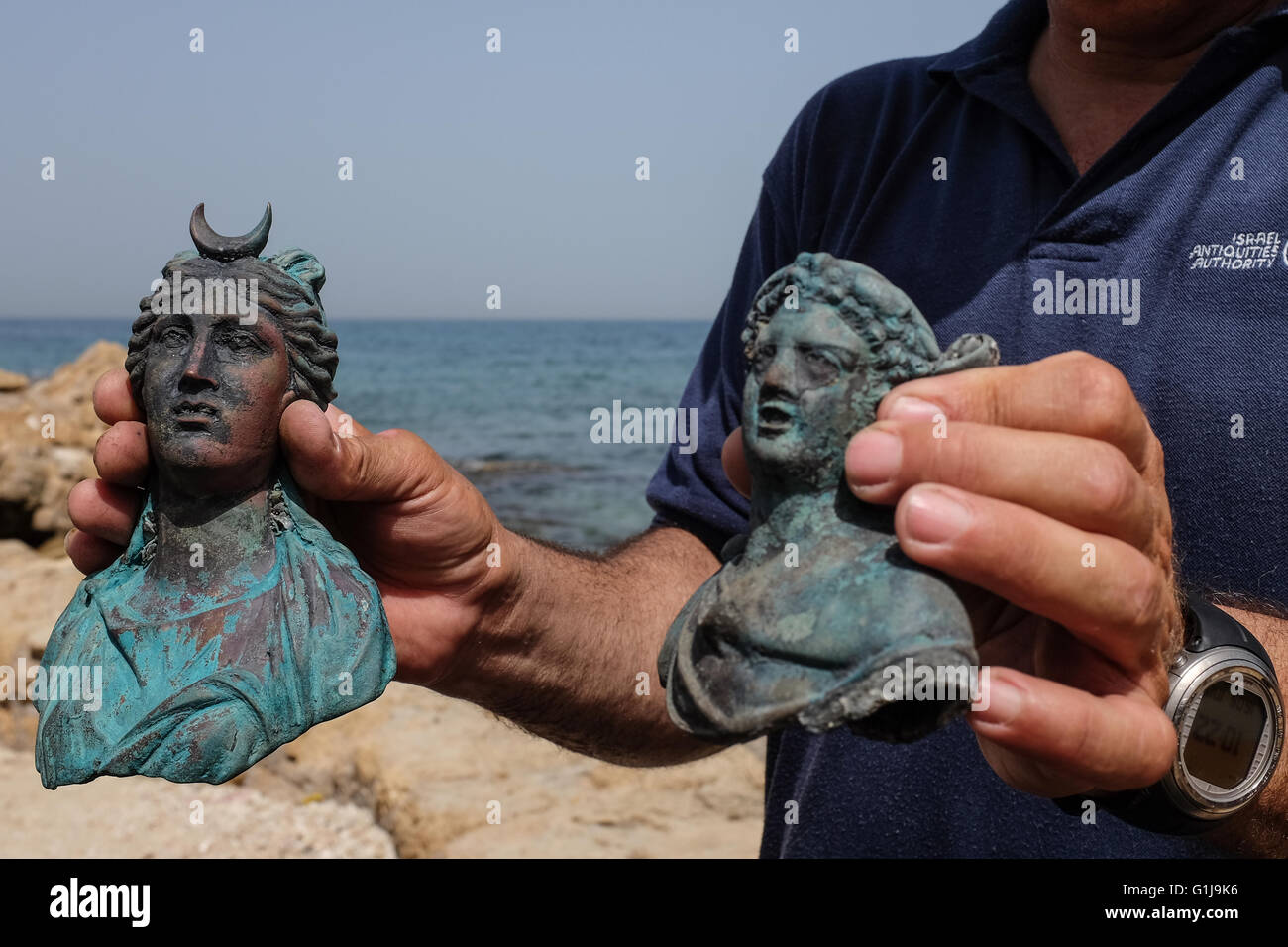 Caesarea, Israel. 16th May, 2016. JACOB SHARVIT, Director of the Marine Archaeology Unit of the Israel Antiquities Authority, holds up figurines of the moon goddess Luna (left) and Dionysus (right), the god of wine. An underwater salvage survey conducted in recent weeks at the ancient Caesarea Harbor by divers from the Israel Antiquities Authority has led to the exposure of a “large, spectacular and beautiful, ancient marine cargo” of a merchant ship that sank during the Late Roman period. Credit:  Nir Alon/Alamy Live News Stock Photo