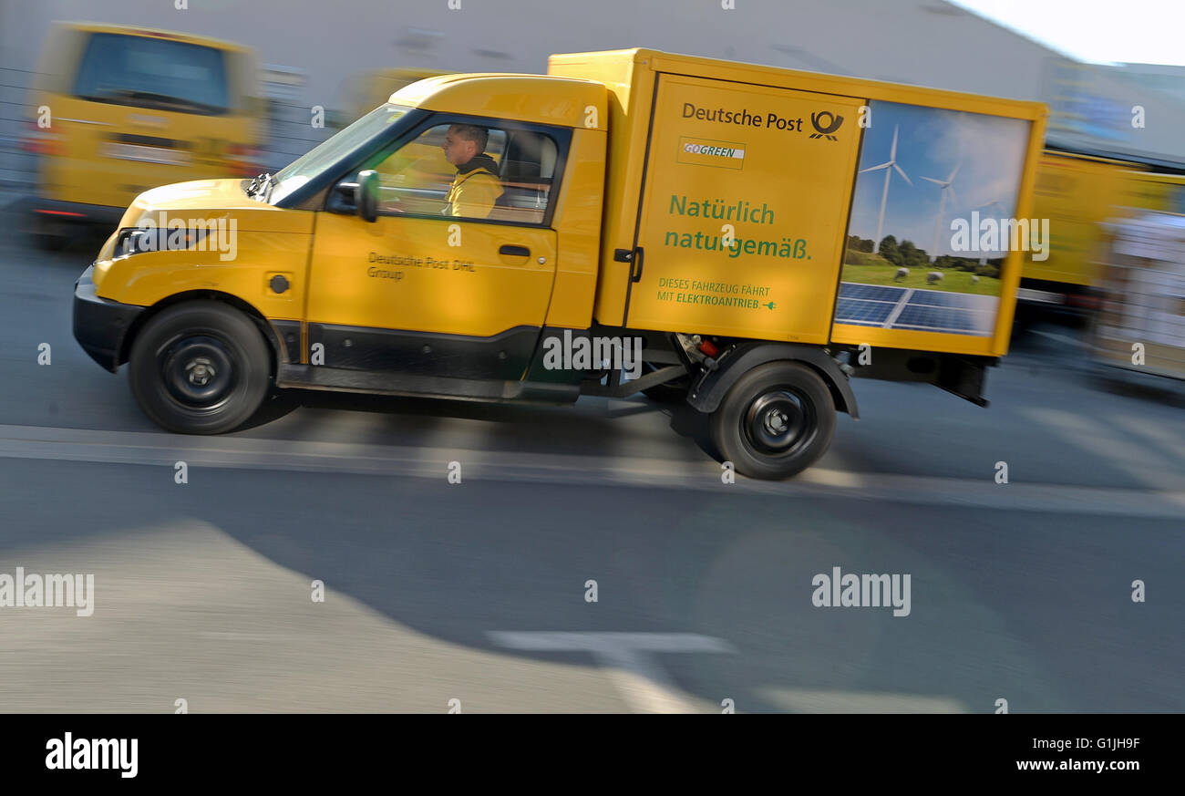 One employee of the Deutsche Post AG drives a new electro delivery truck of the Deutsche Post in the courtyard of the delivery base in Halle/Saale (Saxony Anhalt), Germany, 21 April 2016. Since the middle of the month, the StreetScooters have been used for the mail and parcel delivery in the Halle region. The Deutsche Post DHL Group has developed this vehicle type together with the StreetScooter GmbH and the RWTH Aachen University. Photo: Hendrik Schmidt/dpa Stock Photo