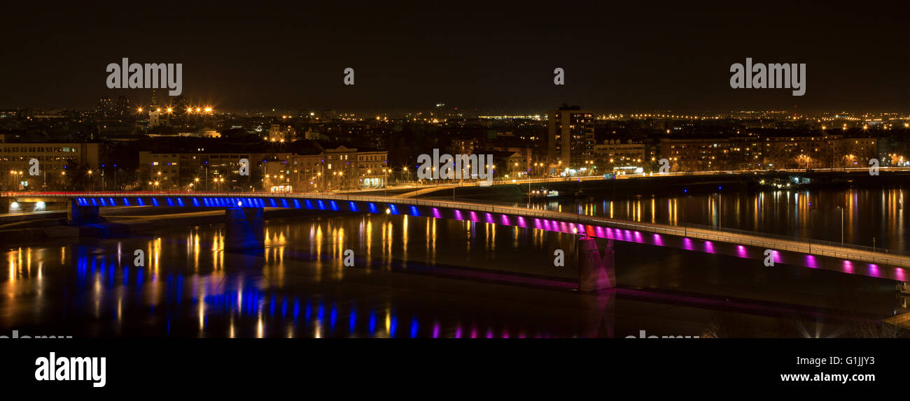 Rainbow bridge in Novi Sad, Serbia at night with view of the city panorama Stock Photo
