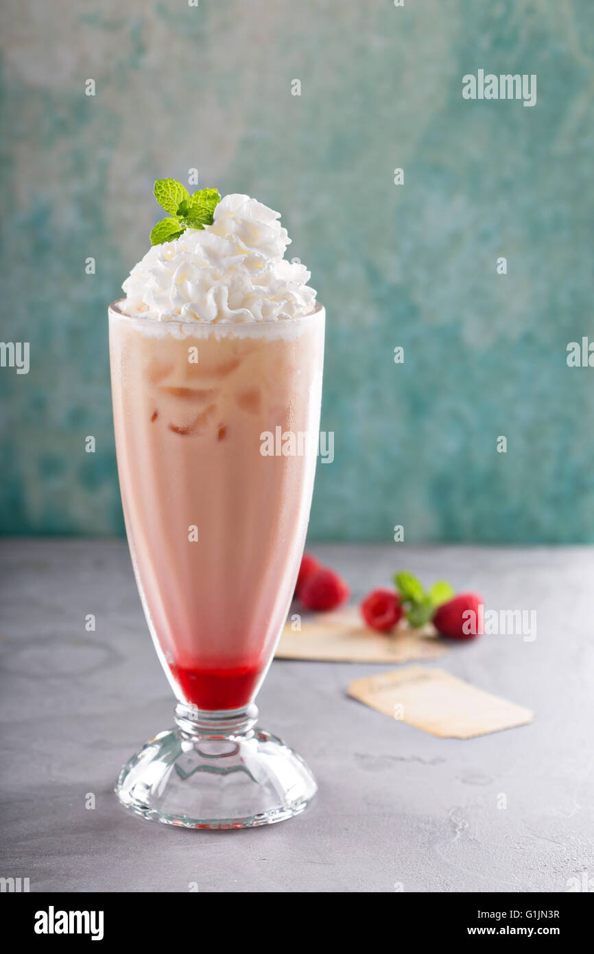 Iced milkshake with raspberry syrup and whipped cream Stock Photo Alamy