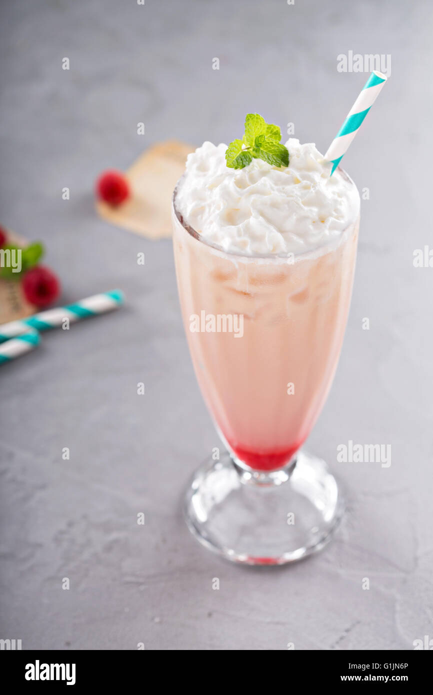 Iced milkshake with raspberry syrup and whipped cream Stock Photo Alamy
