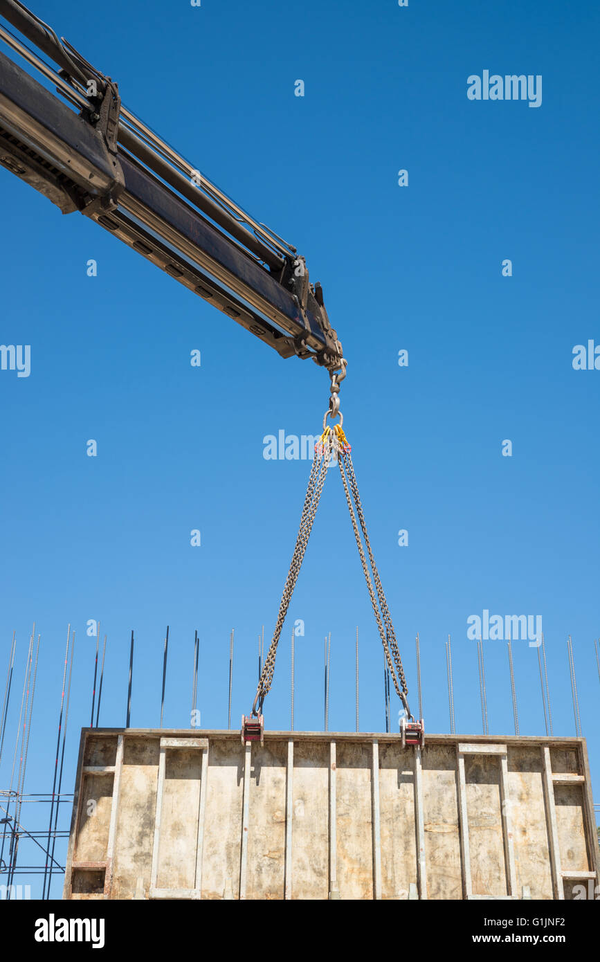 Crane removing a large formwork panel as used for concrete shuttering