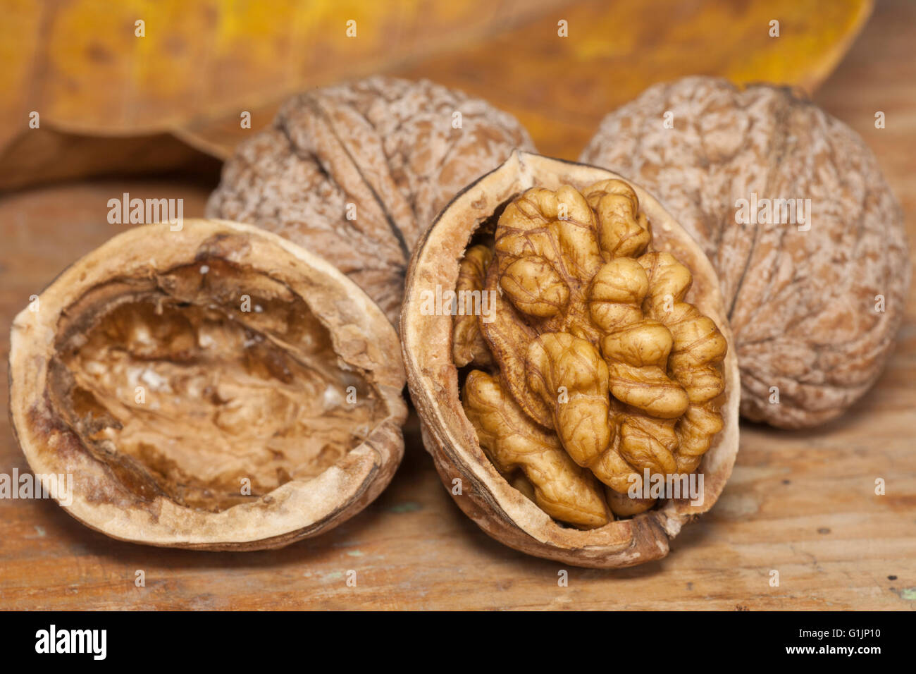 Cracked walnuts on wooden table Stock Photo