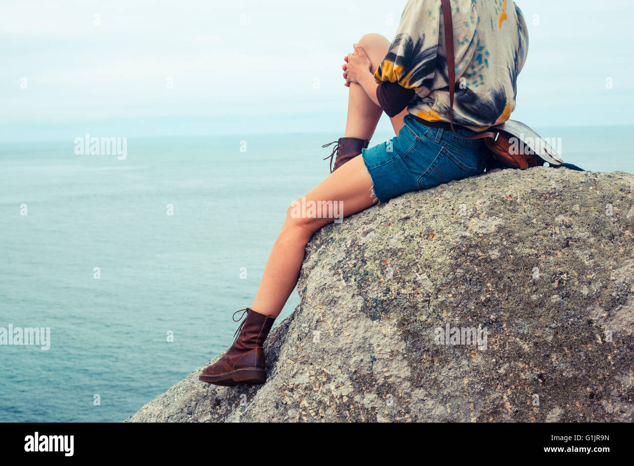 Beautiful woman sitting on rock hi-res stock photography and images - Alamy