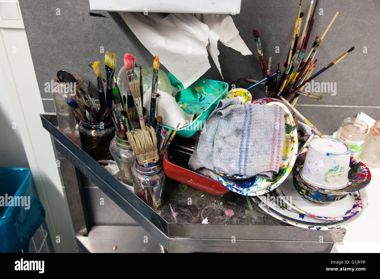 Painter utensils at the sink unit in a atelier of an artist. Stock Photo
