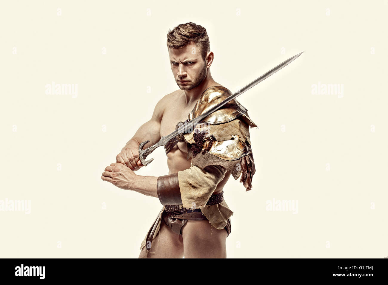 Muscular warrior with sword against of white background Stock Photo - Alamy