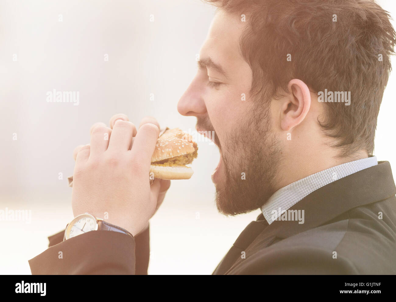 Businessman eating on to go Stock Photo