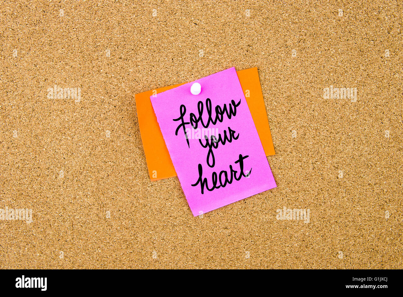 follow-your-heart-written-on-paper-note-pinned-on-cork-board-with-white