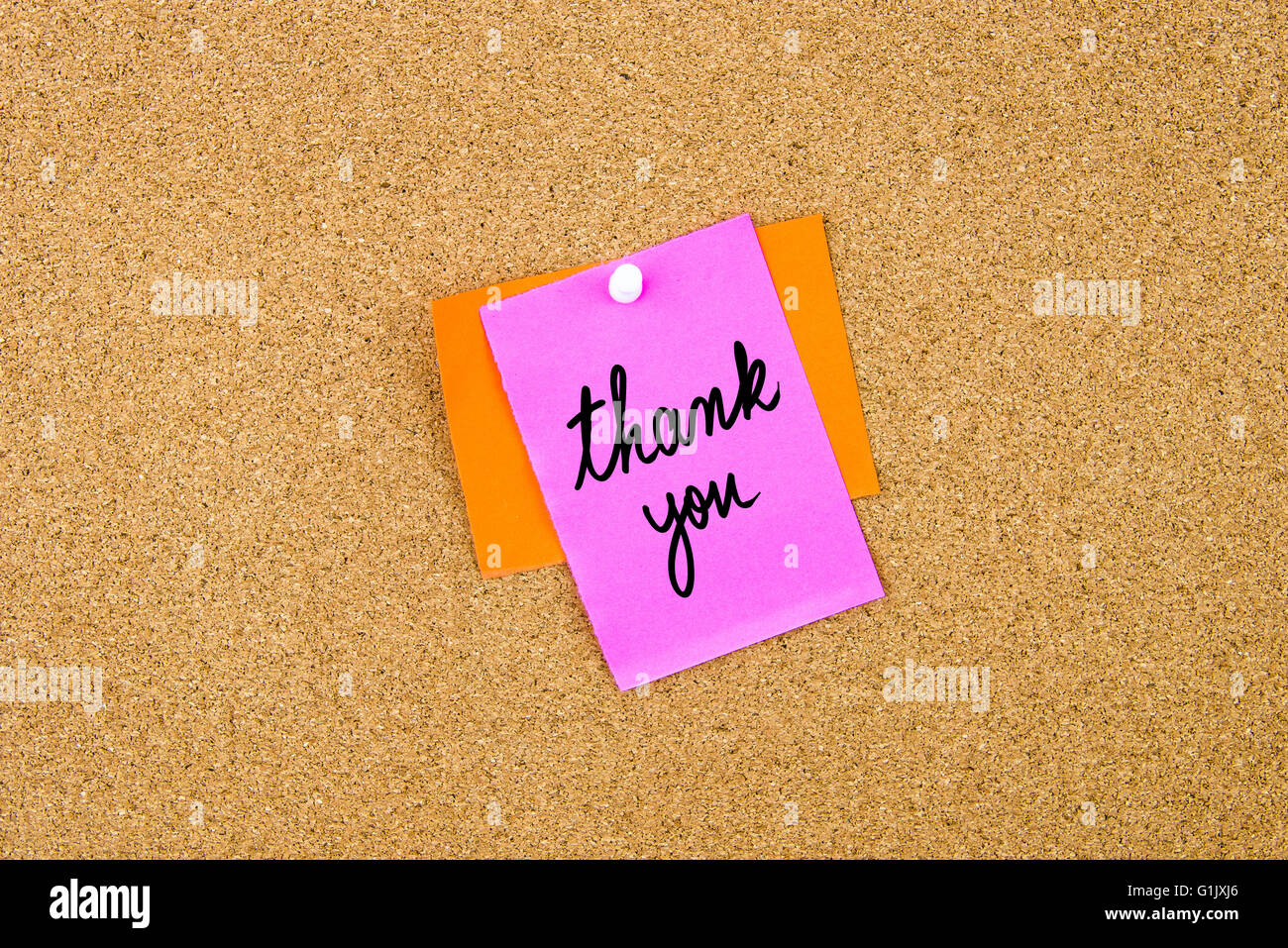 Thank You written on paper note pinned on cork board with white ...