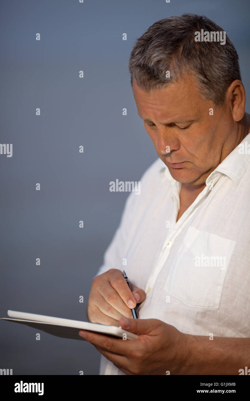 Man Using Pen on Handheld Tablet Computer Stock Photo - Alamy