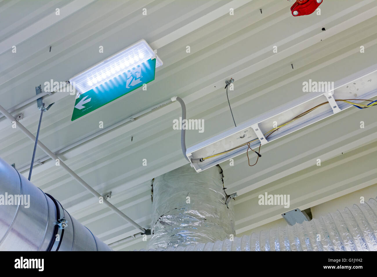 Ceiling with ventilation pipes for air condition and fire exit sign