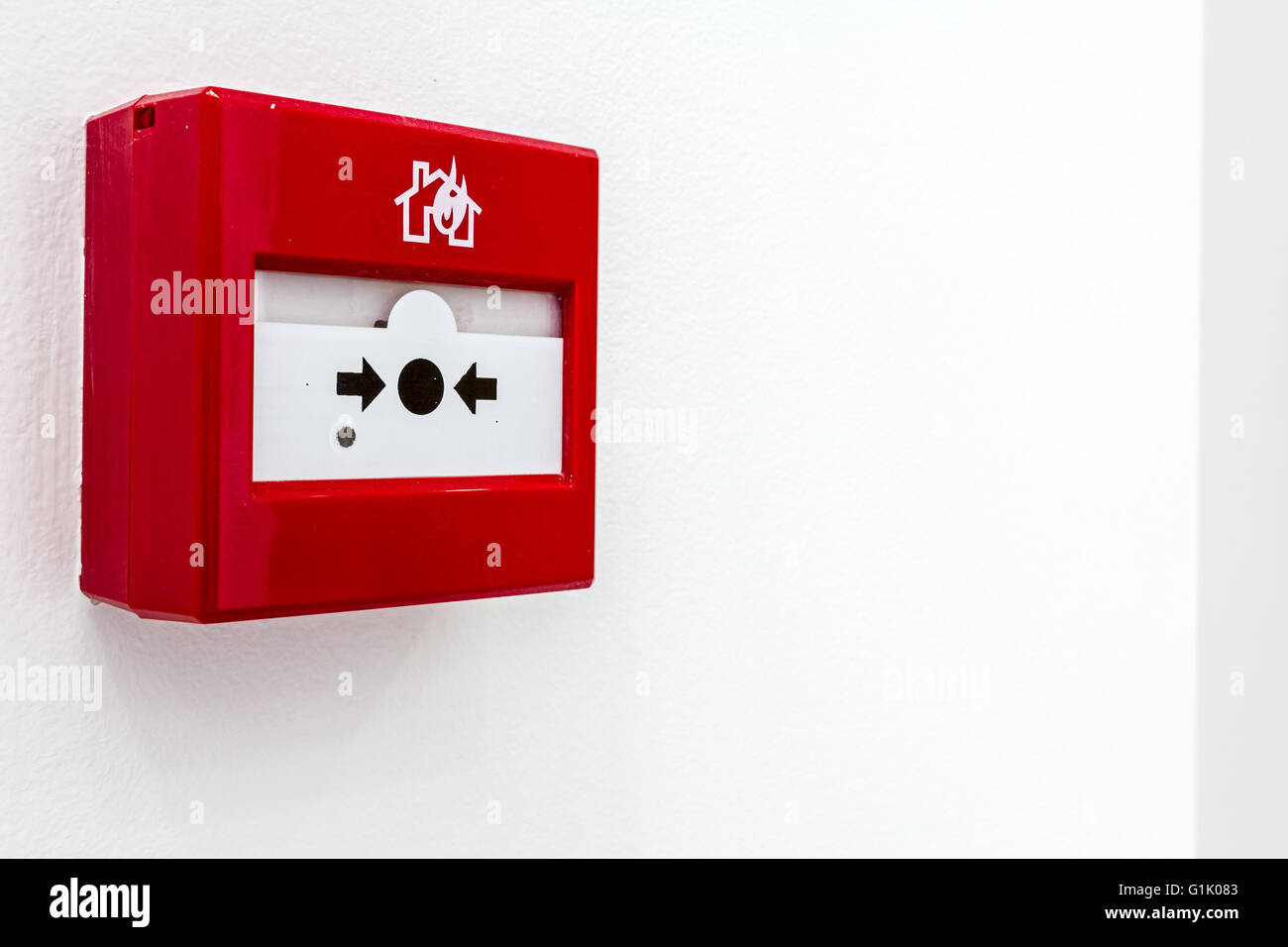 Red fire alarm panel box is on the wall, to smash glass and press button.  Every building is required to have a fire alarm Stock Photo - Alamy