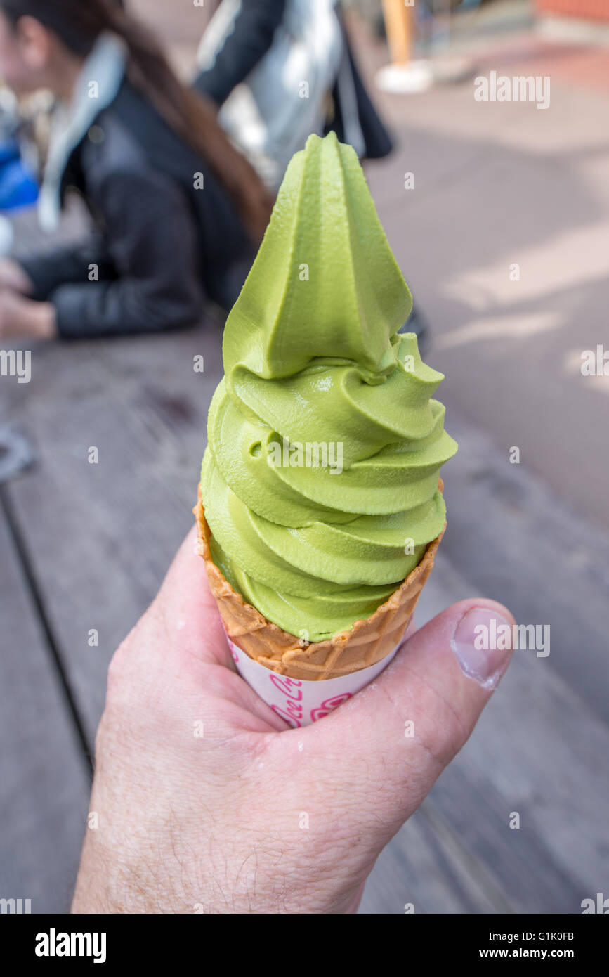 green tea flavored ice cream being held in hand Stock Photo