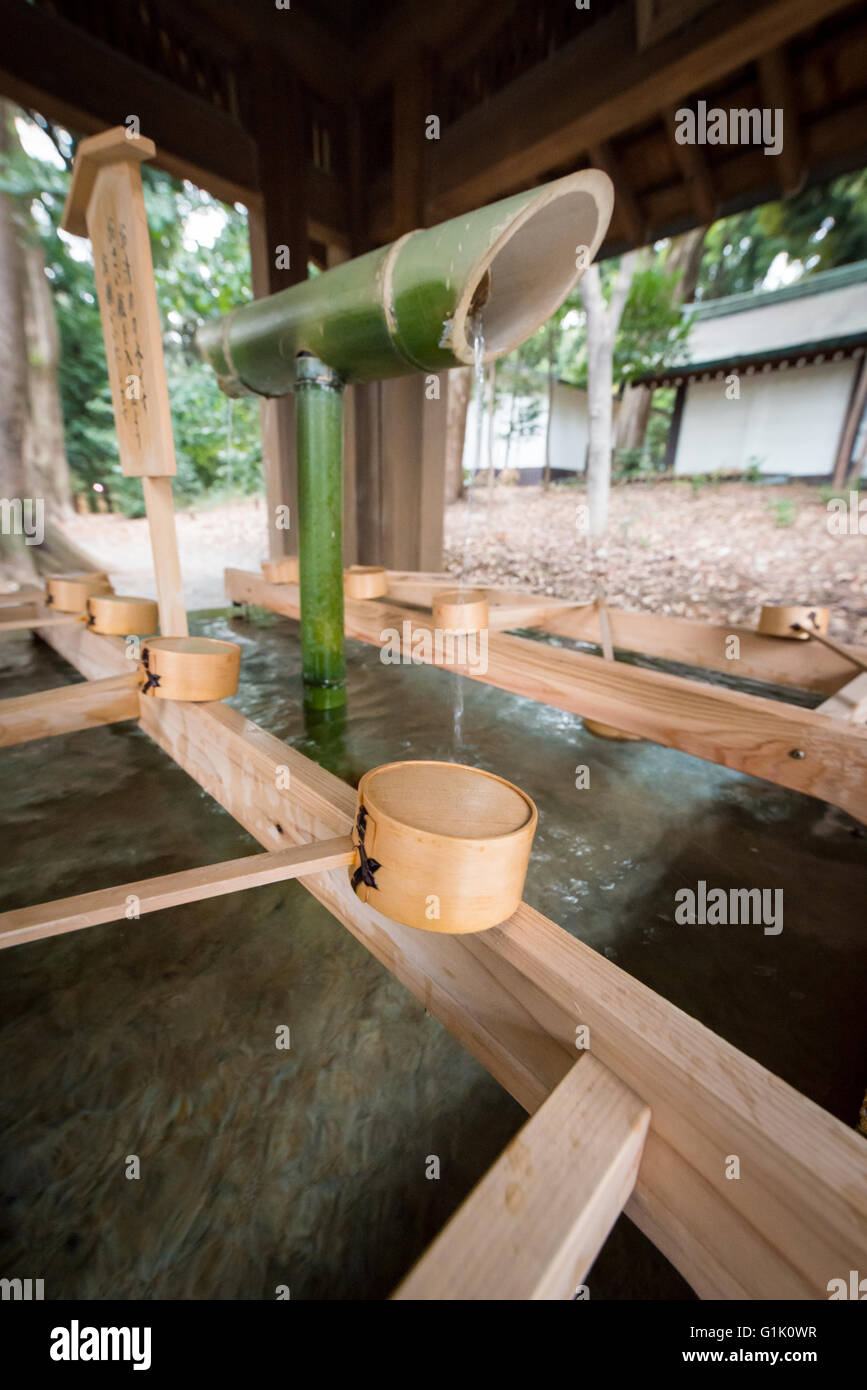 Bamboo water tap and cup for bathing or drinking Stock Photo