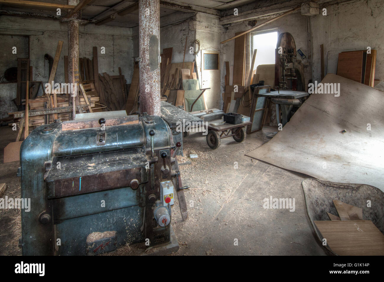 Old and used planing machine in the joinery workshop Stock Photo