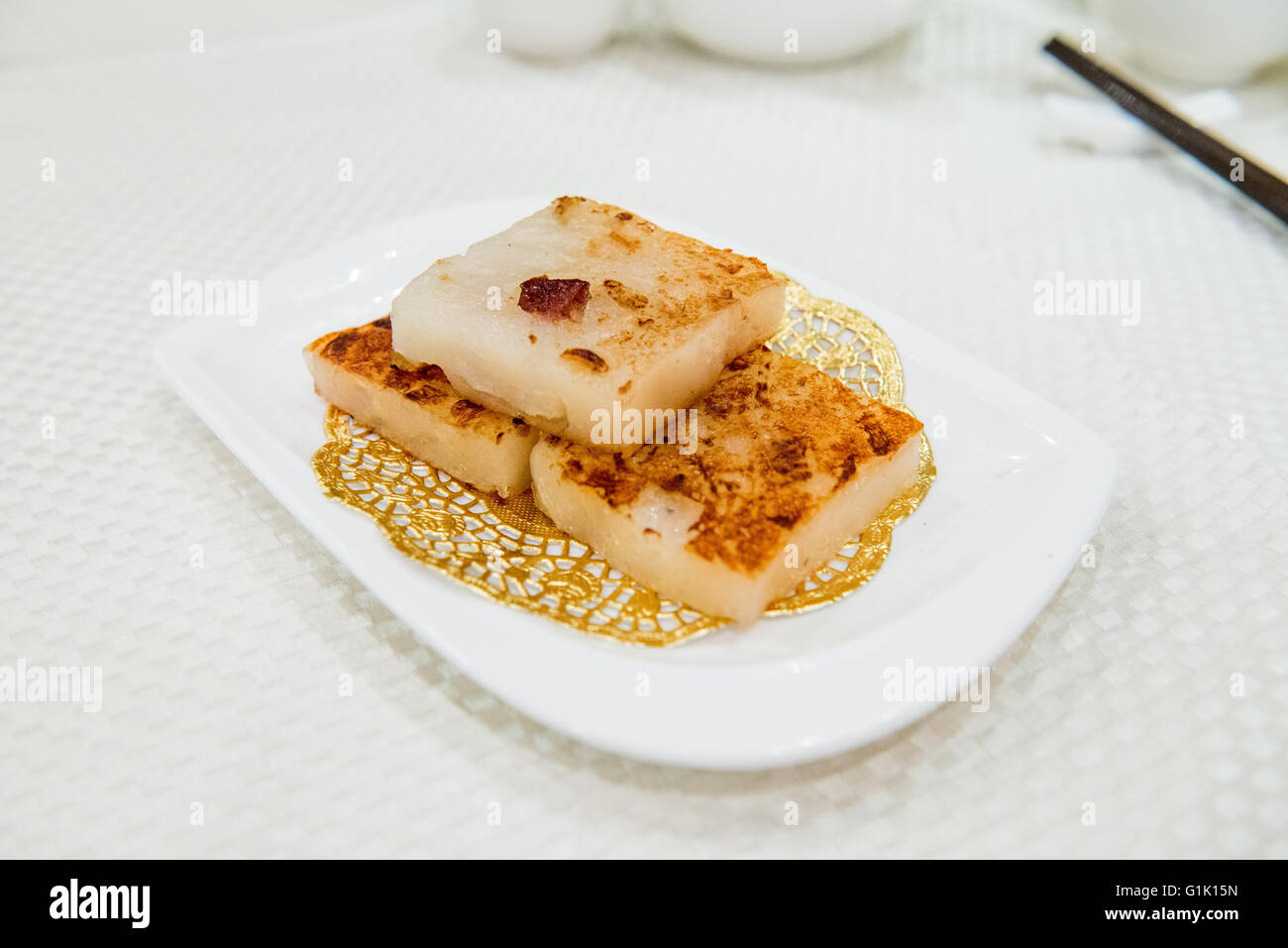 Chinese Dim sum fried turnip paste in a stack on plate Stock Photo