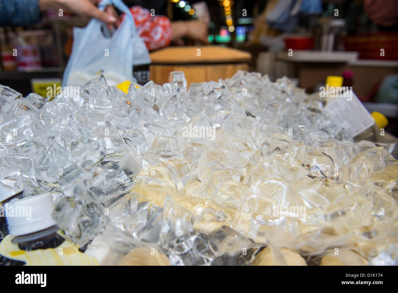 close up of small ice blocks covering drink bottles Stock Photo