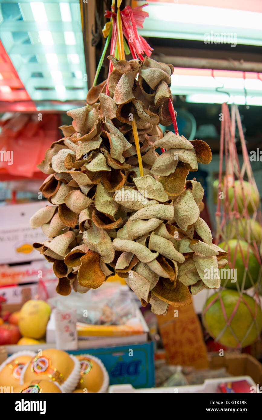 Collection of dried orange skin hanging at market Stock Photo