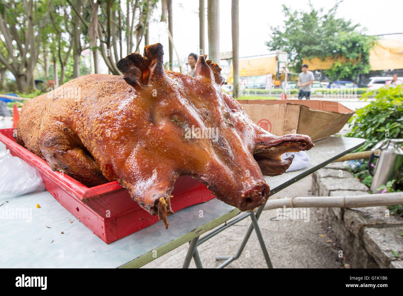 suckling pig roast, whole and presented on  tray outside Stock Photo