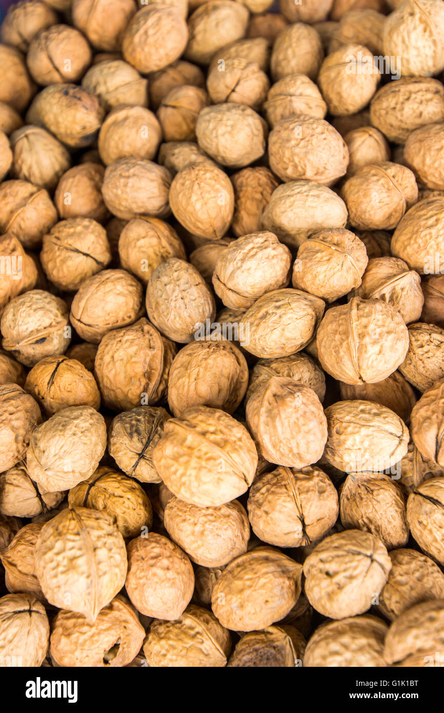 collection of brown hard shelled walnuts on display Stock Photo