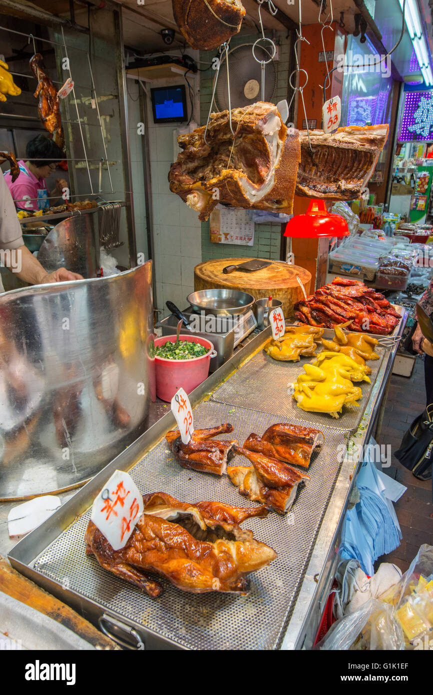 Whole roasted duck and chicken on trays at Chinese market Stock Photo