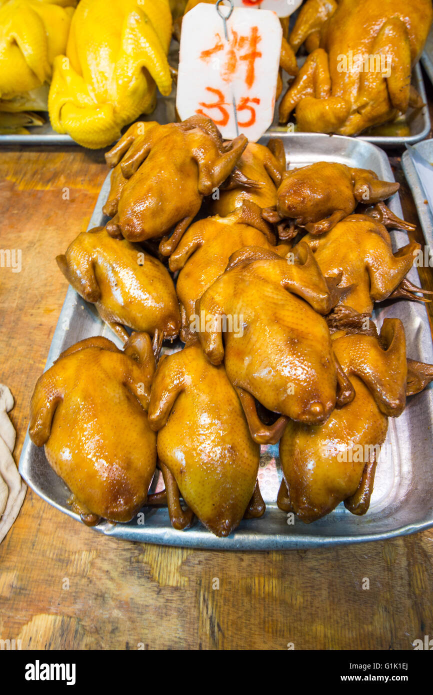 Whole roasted chicken on trays at Chinese market Stock Photo