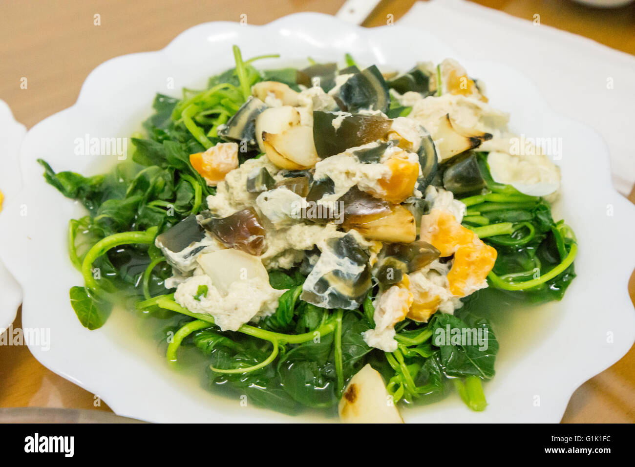 Chinese greens and three styled egg dish Stock Photo