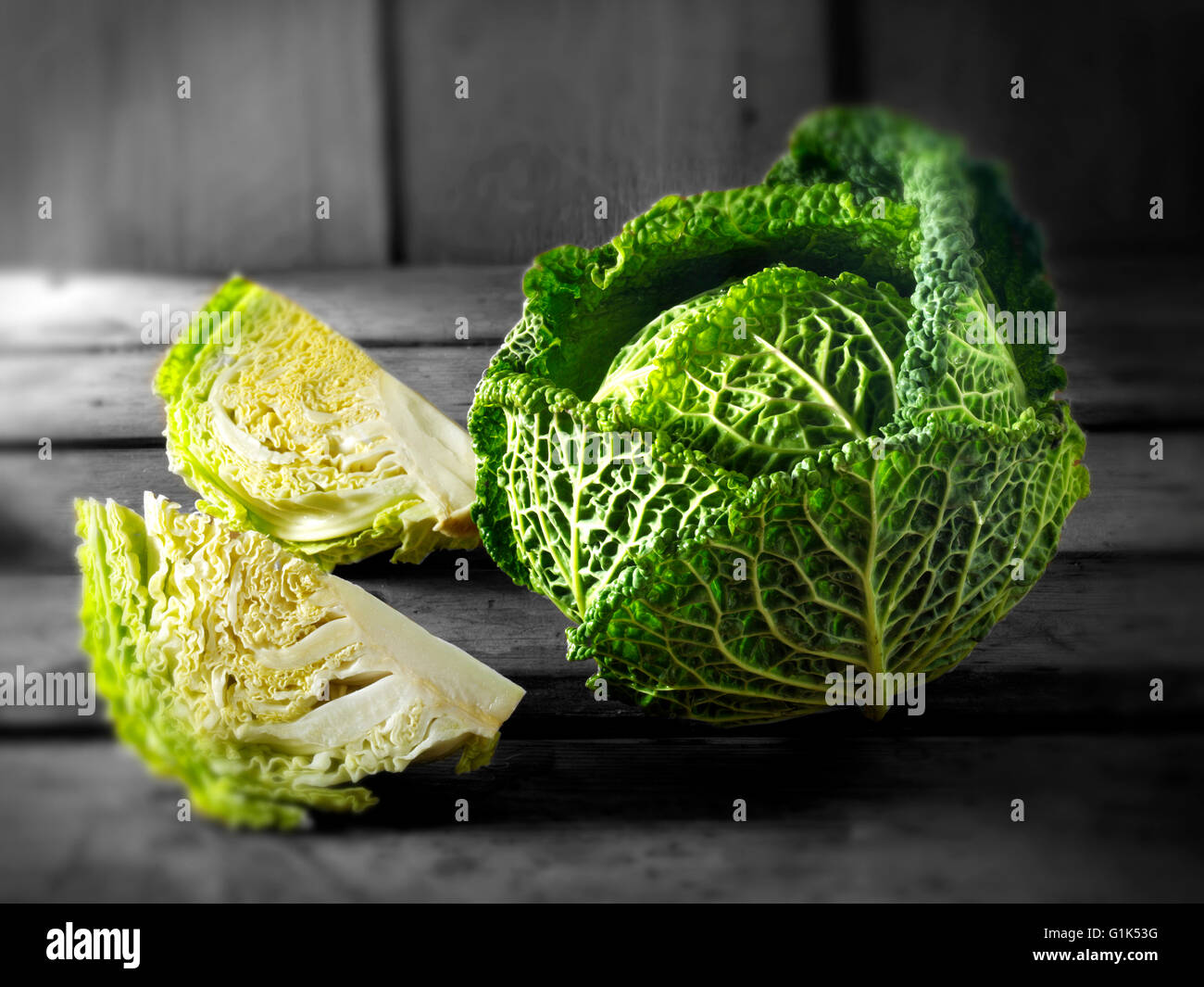 Fresh whole and cut Curly Savoy Cabbage leaves Stock Photo
