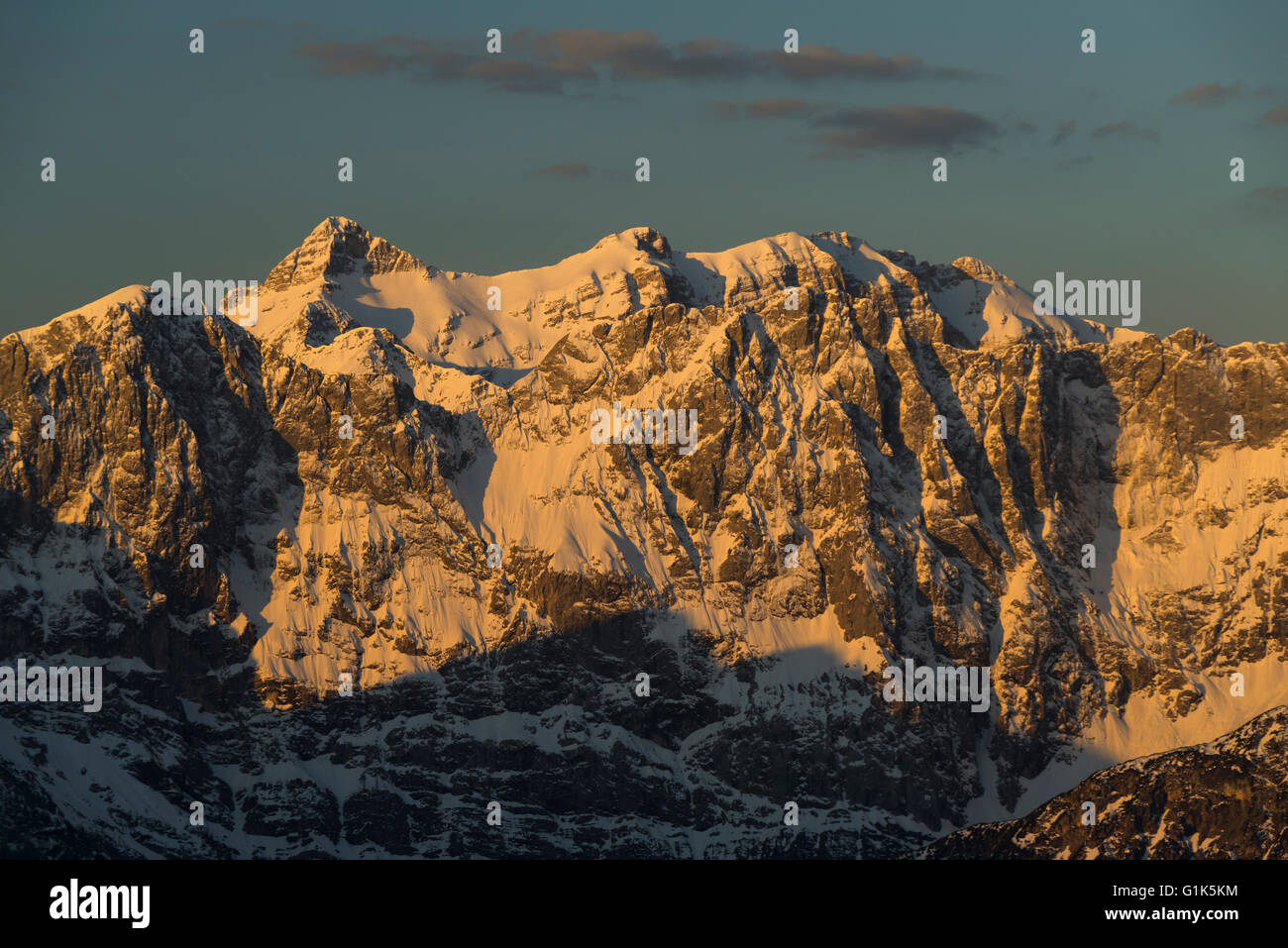 The sunrise illuminates the snowy slopes of Mount Birkkarspitze and Oedkarspitze mountains in the Karwendel range,Tirol,Austria Stock Photo