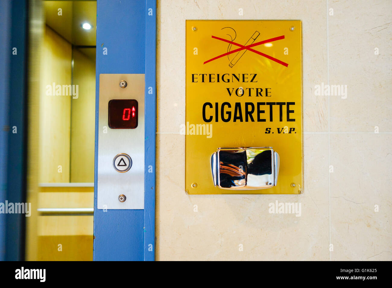 Sign, ashtray next to elevator, french, France. Stock Photo