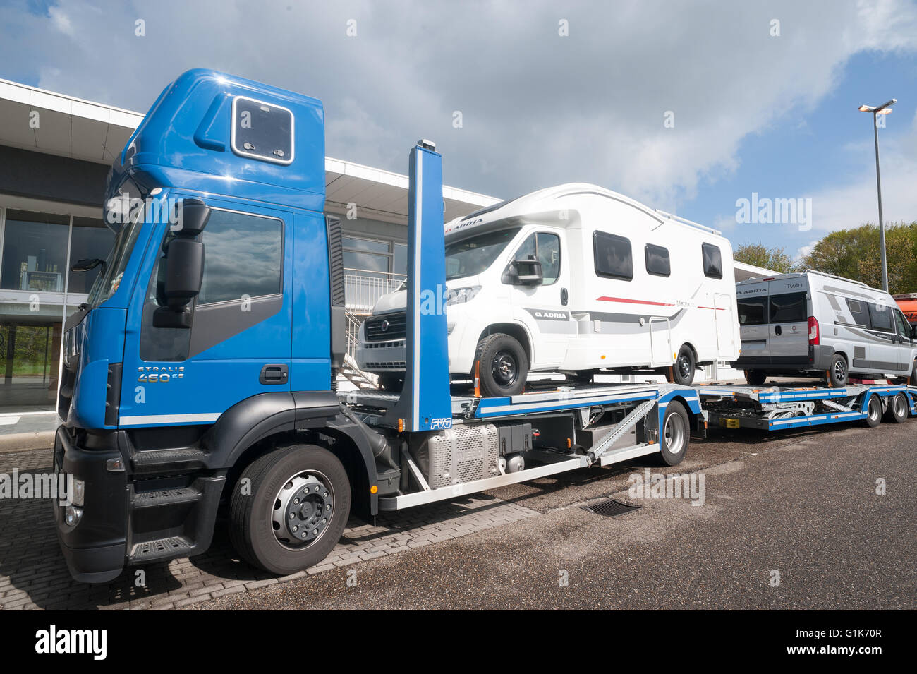 Lichtenbusch, Germany, May 3, 2016: Truck transporter carrying RVs, on a public parking place at a truck stop in Germany. Stock Photo