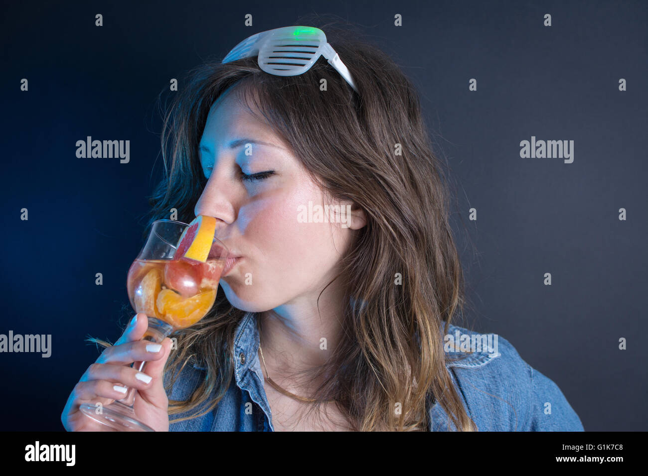 Young woman having a cocktail at the party Stock Photo