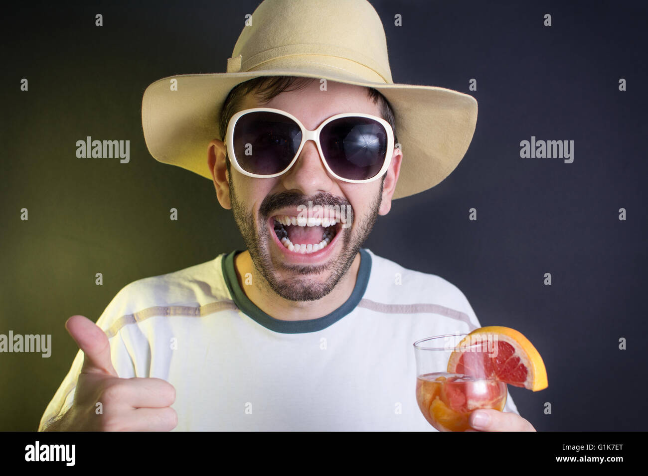 Crazy young man with a cocktail at the party Stock Photo