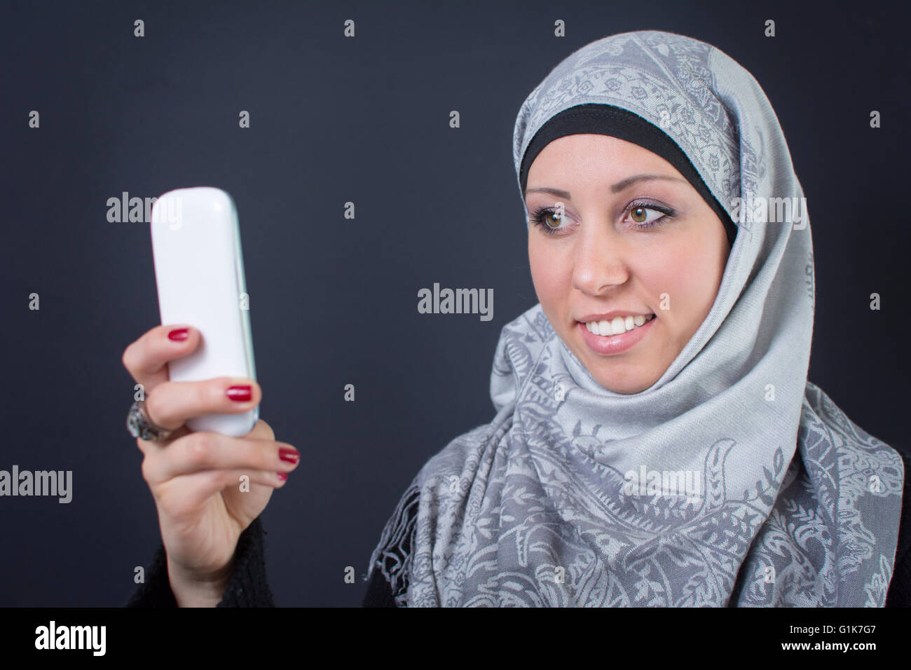 Beautiful muslim woman in hijab making a selfie Stock Photo