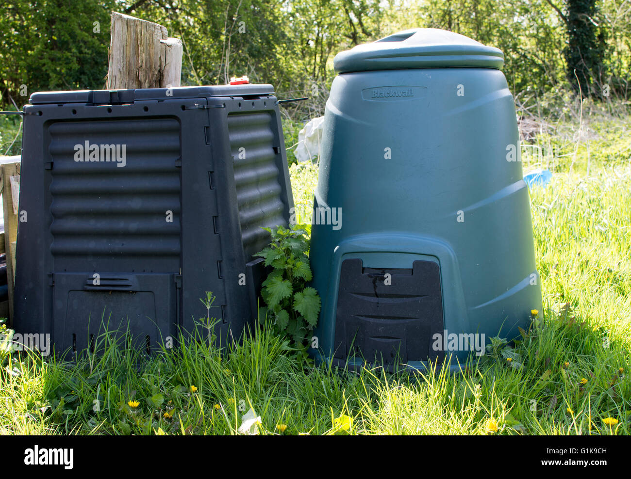 Two plastic compost bins side by side suitable for home use on an