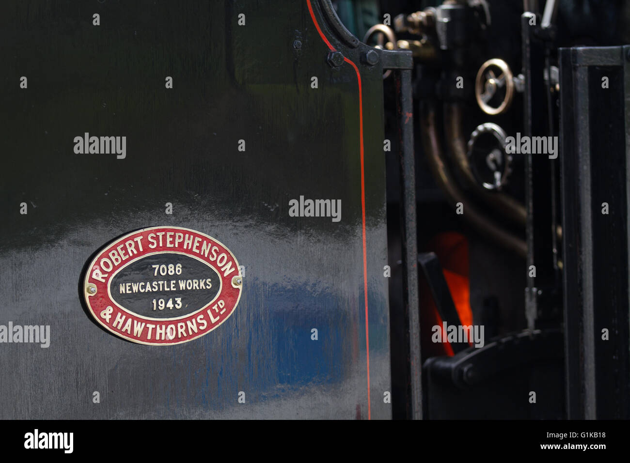 Close crop and a look into the cab of ex National Coal Board - NCB - industrial steam locomotive 35 'Norman' showing the fire Stock Photo