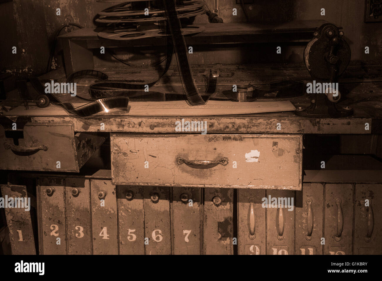 here assassination Melting Vintage movie film reels on splicing table in old theater in sepia Stock  Photo - Alamy