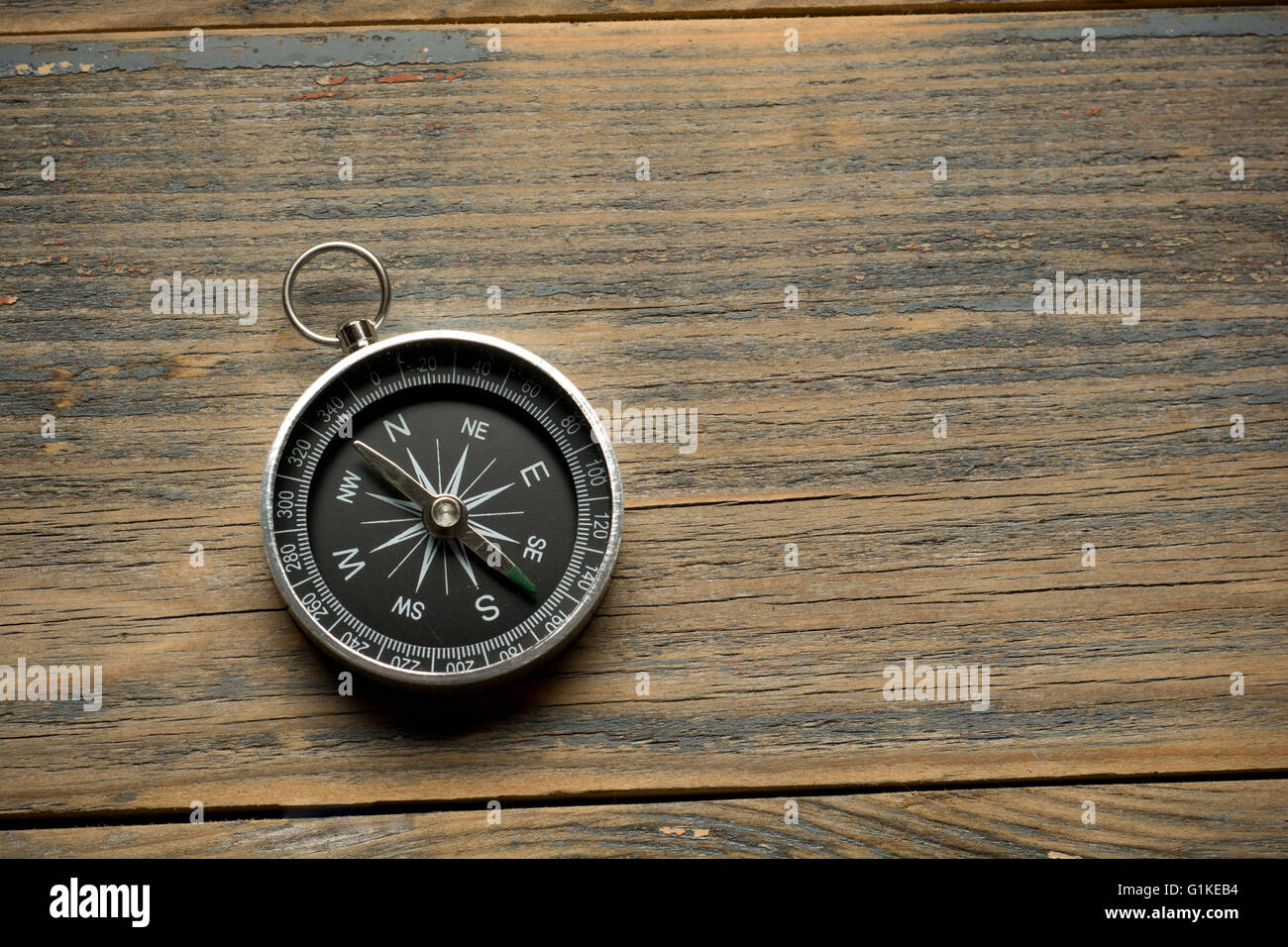 compass on the brown wooden table background Stock Photo