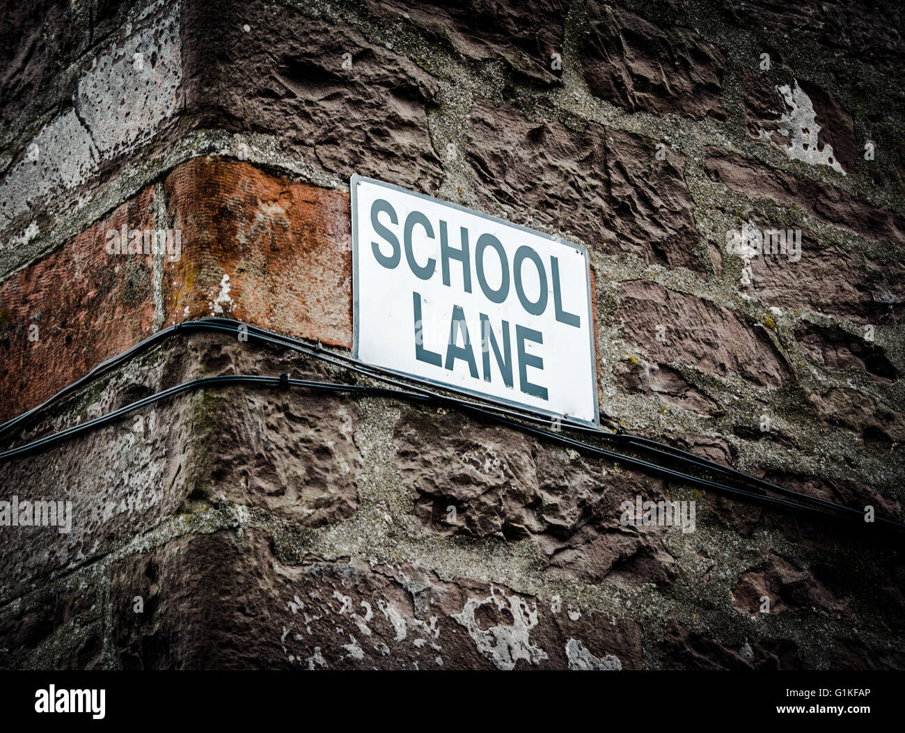 A Sign With School Lane On The Side Of A Building In The UK Stock Photo