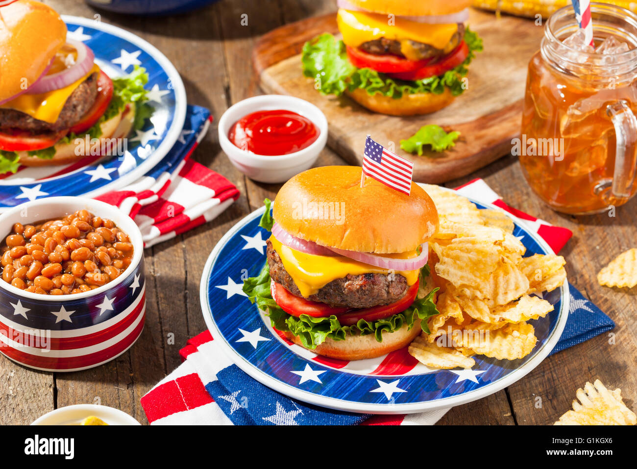 Homemade Memorial Day Hamburger Picnic with Chips and Fruit Stock Photo
