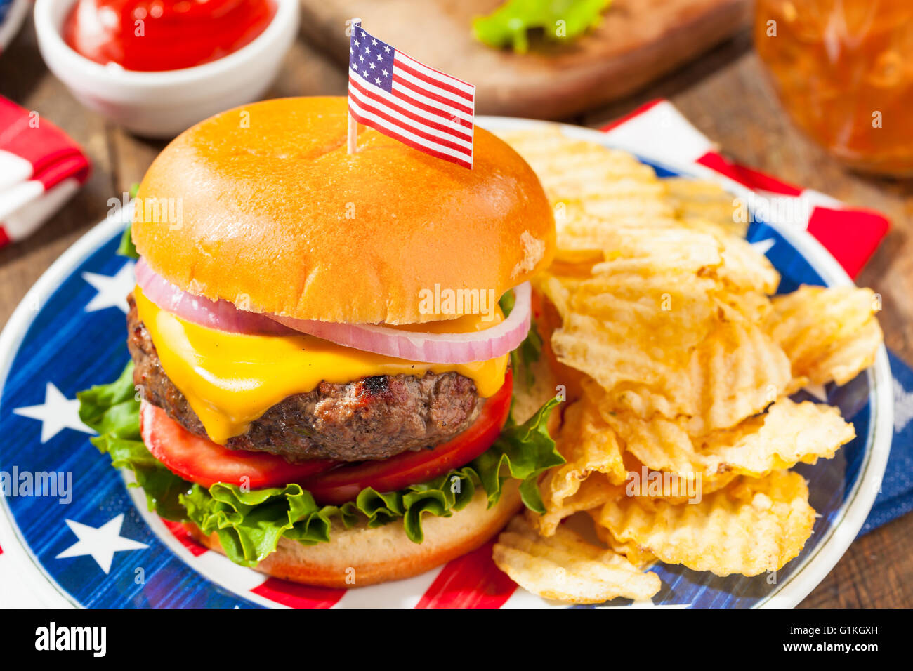 Homemade Memorial Day Hamburger Picnic with Chips and Fruit Stock Photo