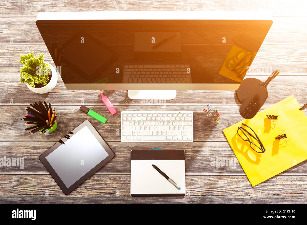 Office workplace with tablet and pc on wood table. Stock Photo