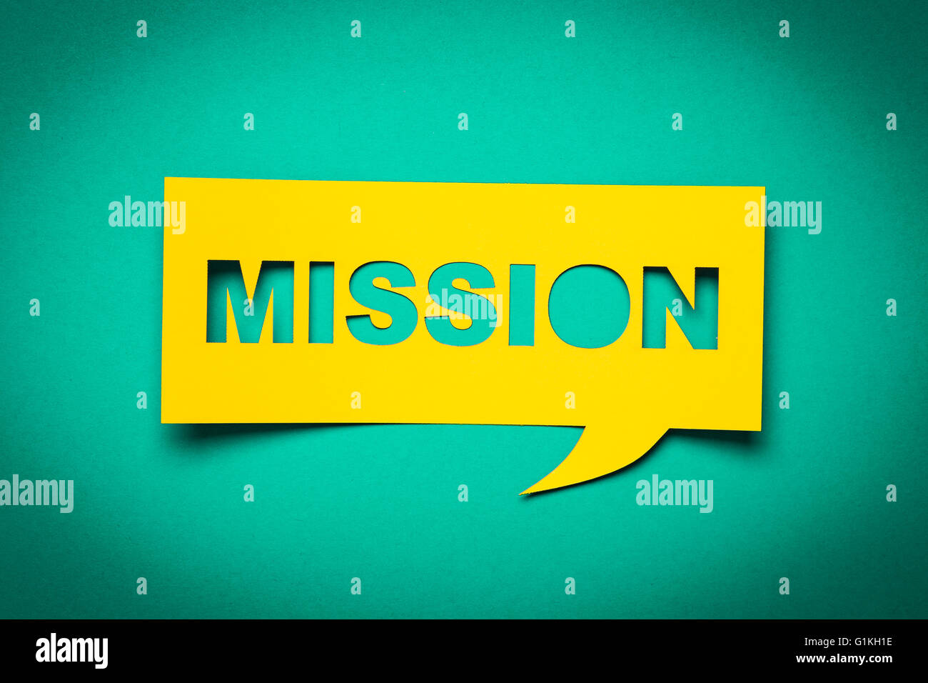 Bubble speech with cut out phrase 'mission' in the paper. Stock Photo