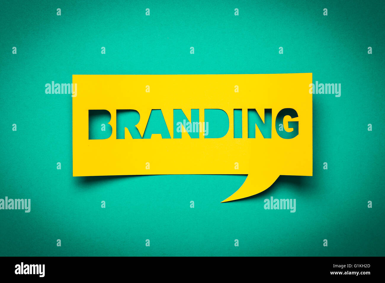 Bubble speech with cut out phrase 'branding' in the paper. Stock Photo