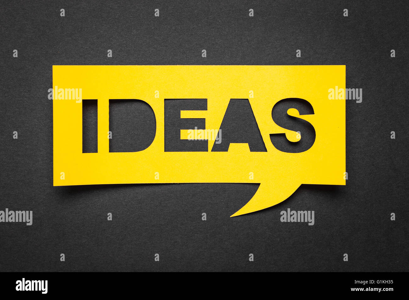 Bubble speech with cut out phrase "ideas" in the paper. Stock Photo