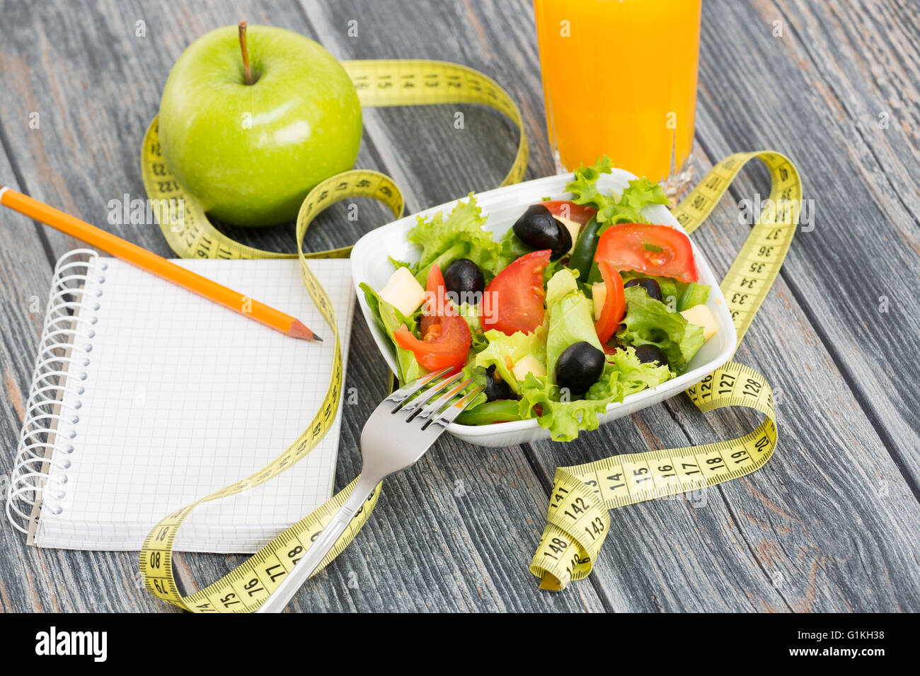 Workout and fitness dieting copy space diary on wooden table. Stock Photo