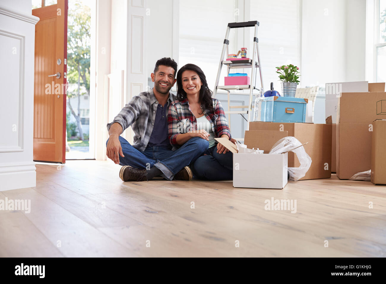 Portrait Of Hispanic Couple Moving Into New Home Stock Photo - Alamy