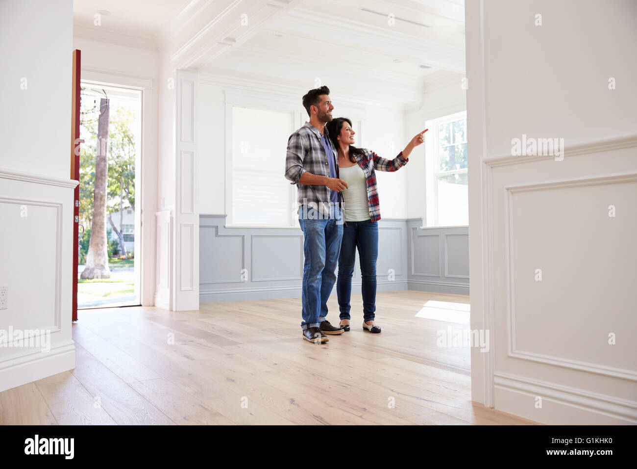 Hispanic Couple Viewing Potential New Home Stock Photo