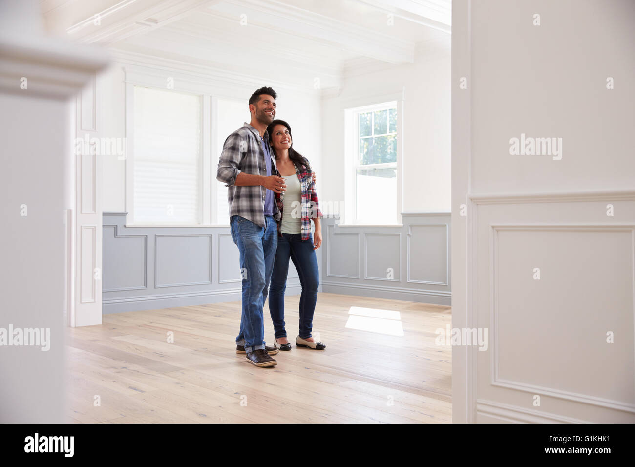 Hispanic Couple Viewing Potential New Home Stock Photo